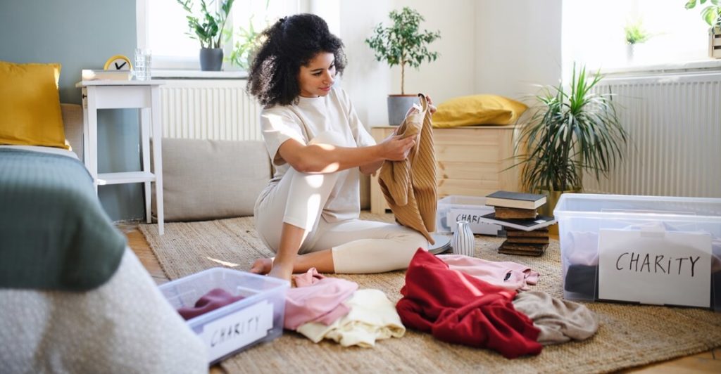 Young woman decluttering her home.
