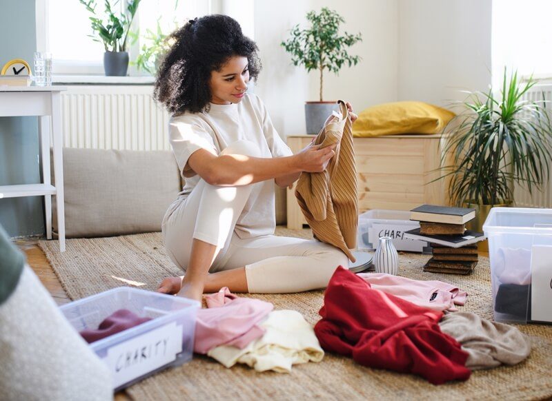 Young woman decluttering her home.