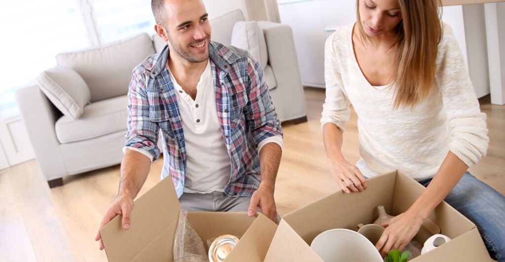 Young couple packing items for self storage.
