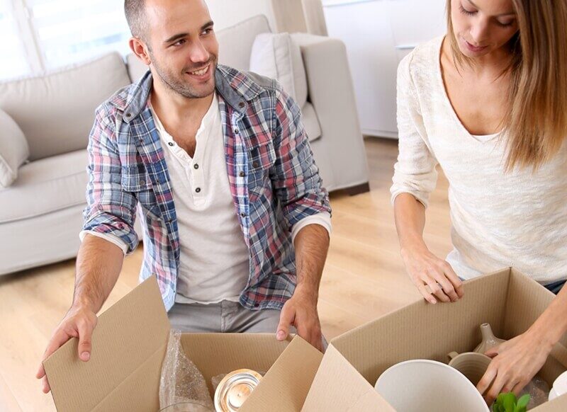Young couple packing items for self storage.