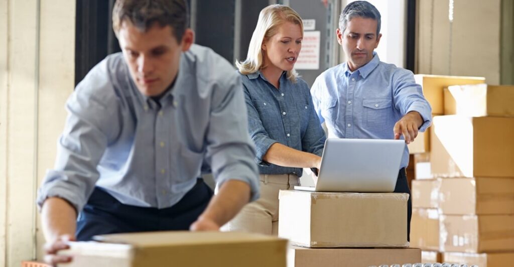 Small business workers using self storage for stock storage.