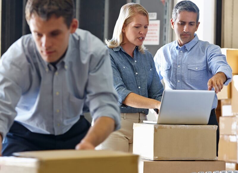 Small business workers using self storage for stock storage.